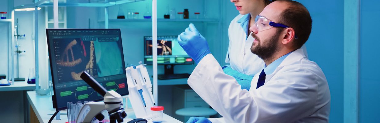 Chemist nurse holding test tubes bringing to doctor conducting DNA experiment discussing about medical treatment working overtime. Stuff examining virus evolution using high tech researching diagnosis
